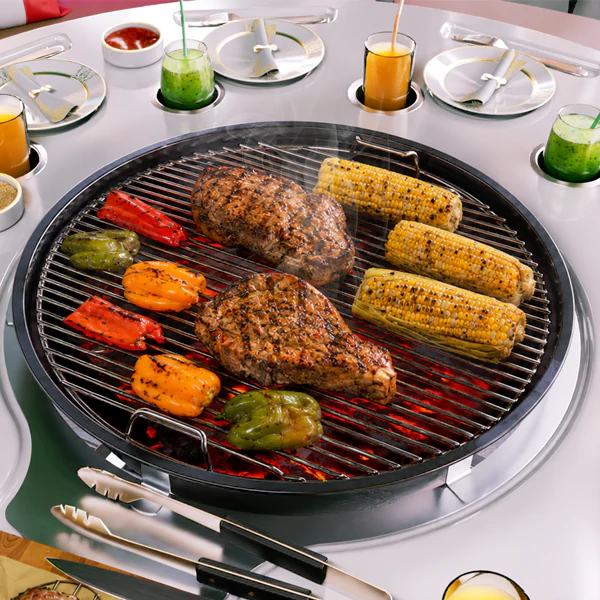 Round BBQ boat grill table with grilled steaks, corn, peppers, fresh juices, and dining settings for outdoor boat parties